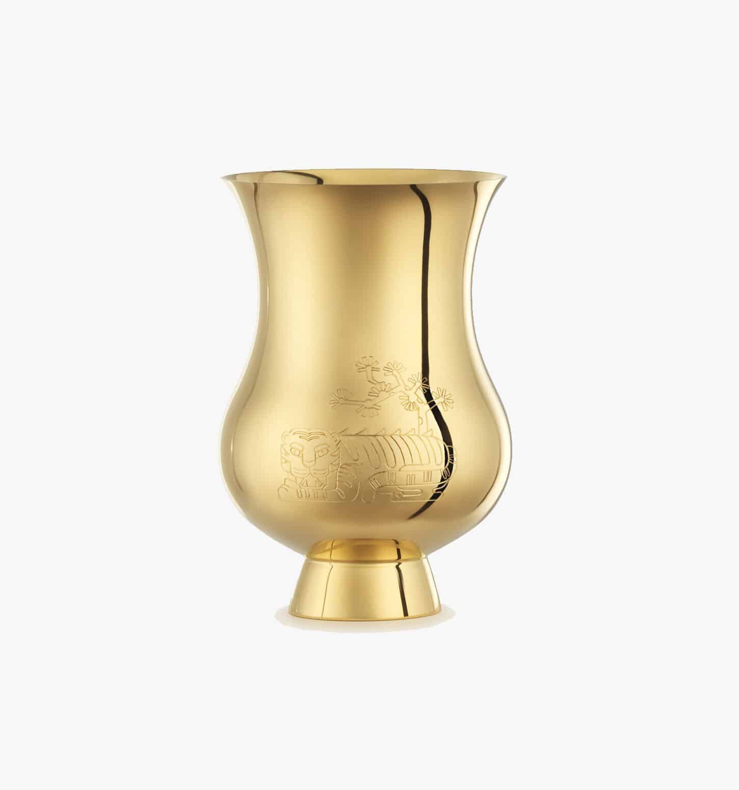 Timpani engraved with the zodiac sign of the "Year of the Tiger" in vermeil from the Pour le champagne collection by Puiforcat on a light background.