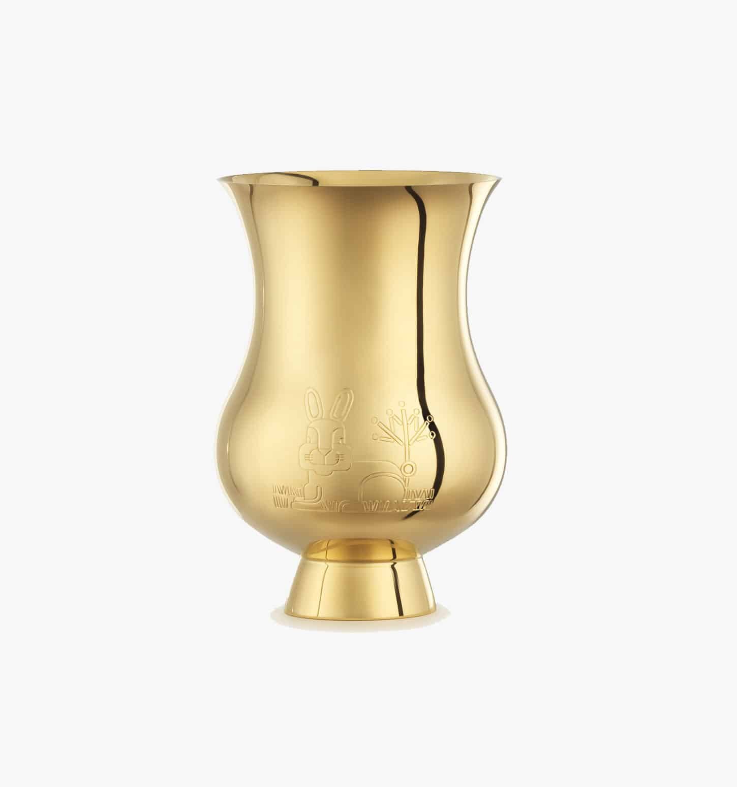 Tumbler engraved with the zodiac sign of the "Year of the Rabbit" in vermeil from the Pour le champagne collection by Puiforcat on a light background.